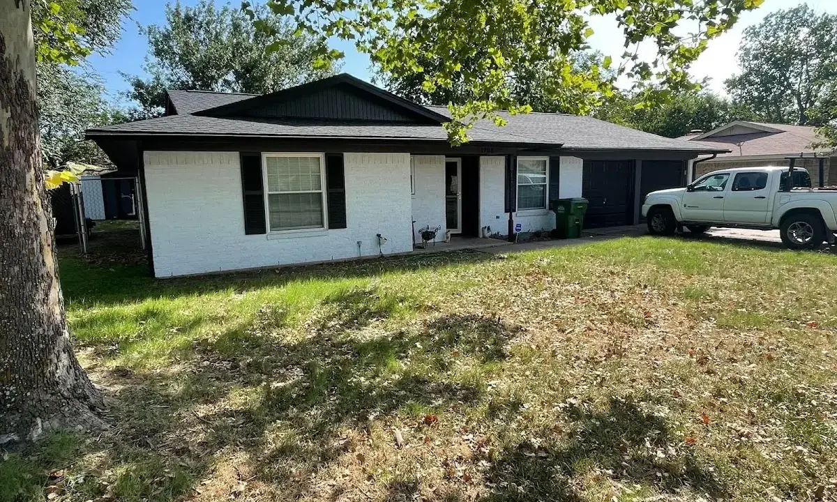Professional roofing crew working on a residential roof in Missouri City